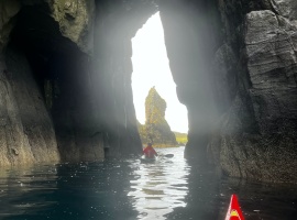 Kayaking through arch, Skye