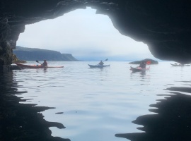 Kayakers at cave mouth